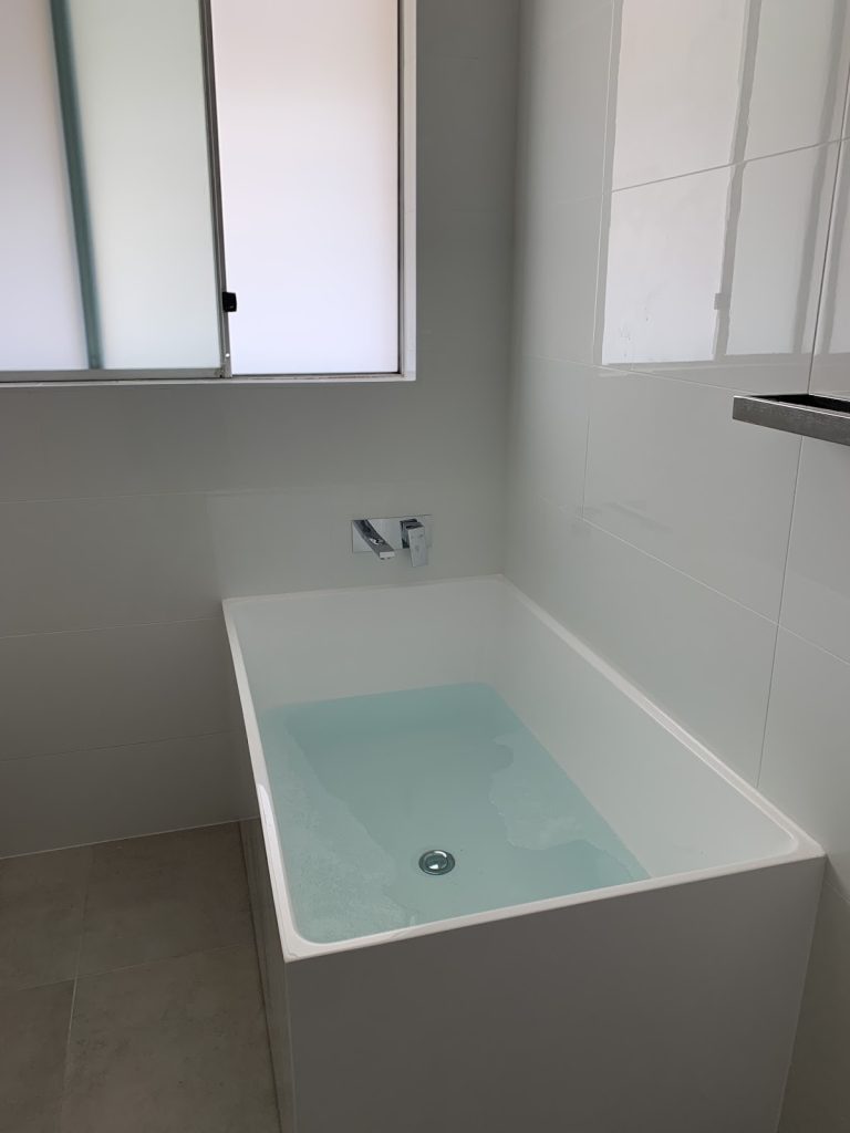 Installed bathtub during bathroom renovation